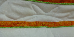 name with date embroidered before sewing binding on